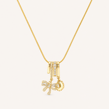 Gold-tone bow and sun charm necklace