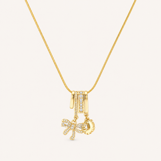 Gold-tone bow and sun charm necklace