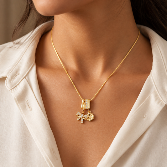 Crystal bow and sun charm necklace