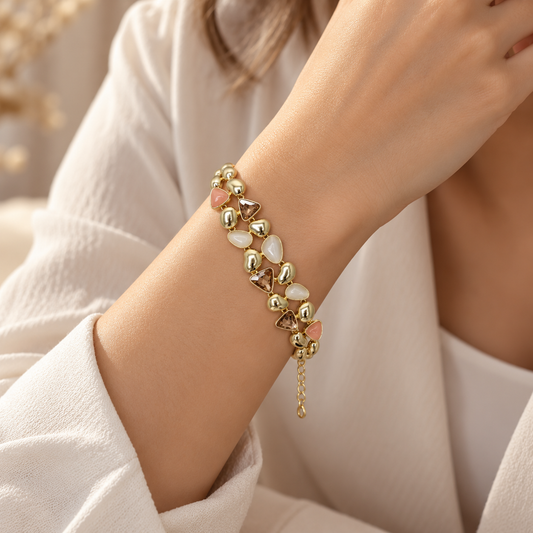 Model wearing ANOVRA gold-tone pastel mosaic bracelet with geometric stone detailing