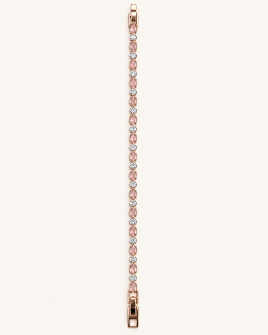 Rose gold tone blush pink bracelet featuring alternating oval pink stones and sparkling clear round stones on a light background.