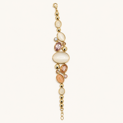 ANOVRA Pastel Aura gold tone bracelet featuring ivory and peach oval stones, sparkling crystal accents, polished gold beads and adjustable chain.
