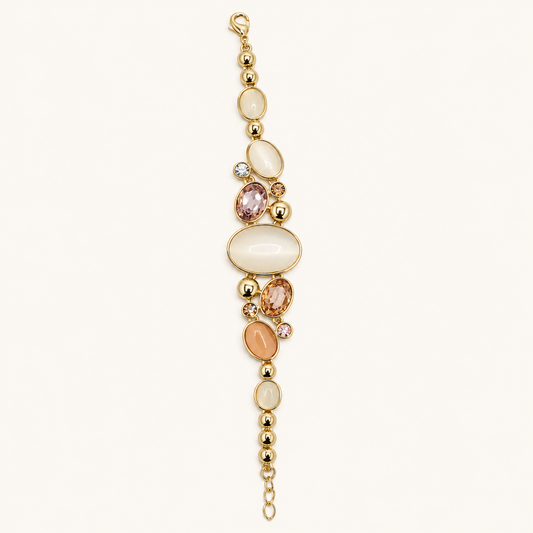 ANOVRA Pastel Aura gold tone bracelet featuring ivory and peach oval stones, sparkling crystal accents, polished gold beads and adjustable chain.