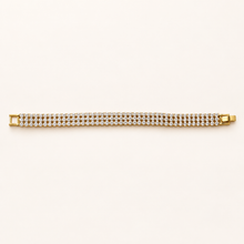 Golden Radiance gold tone multi-row stone bracelet displayed flat on a cream background