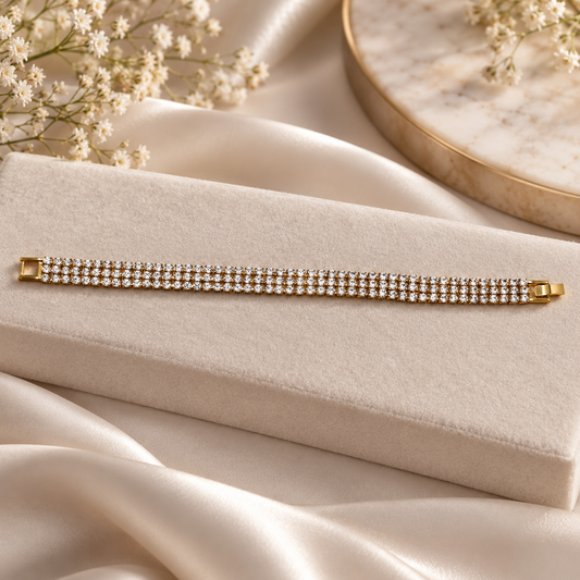 Elegant gold tone multi-row stone bracelet styled with luxury props for jewellery photography