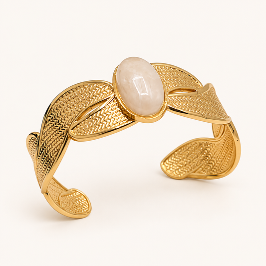 Anovra gold leaf cuff bracelet with ivory oval stone on cream background