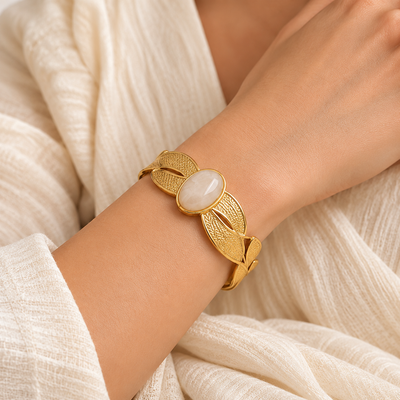 Anovra gold textured cuff bracelet worn on wrist by female model