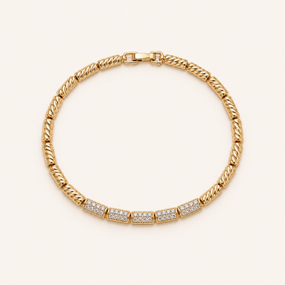 Gold crystal link bracelet on soft cream background
