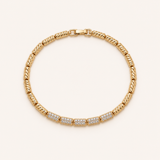 Gold crystal link bracelet on soft cream background