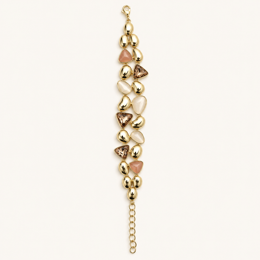 Gold-tone pastel mosaic statement bracelet with polished sculptural links, pink and white accents, champagne-toned stones, and adjustable chain.