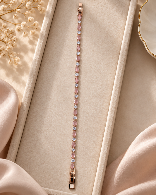 Elegant blush crystal bracelet featuring rose gold tone settings, pink oval stones and sparkling clear accents styled with minimal luxury props.