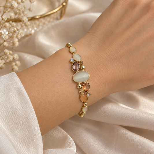 Model wearing ANOVRA Pastel Aura Bracelet on wrist, showcasing elegant pastel gemstones, gold tone detailing and sparkling crystal accents.