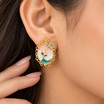 Designer enamel earrings featuring floral artwork, green leaves and sparkling stone details