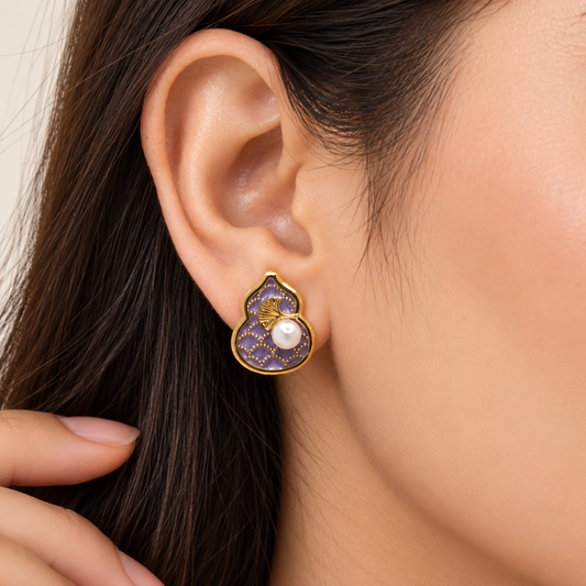Elegant purple pearl earrings with gold-tone ginkgo leaf design