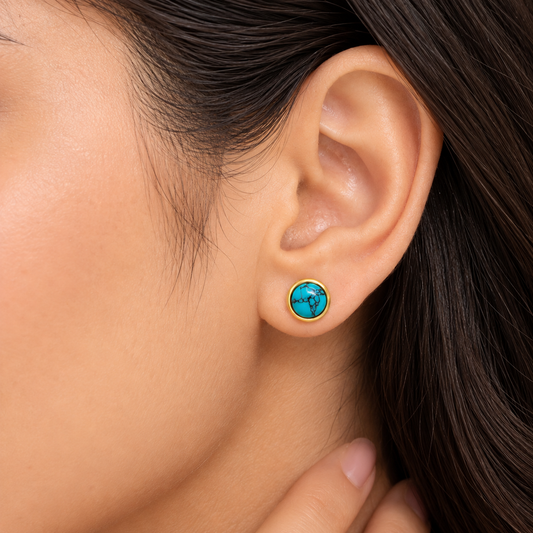 Round blue stone-inspired earrings with polished gold frame