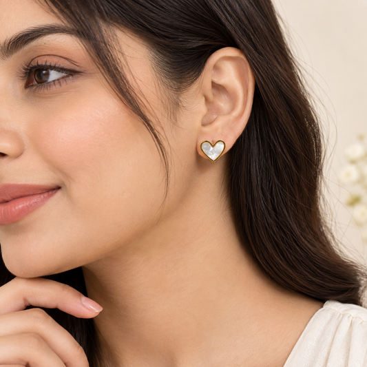 Heart-shaped stud earrings with luminous white centre and gold border