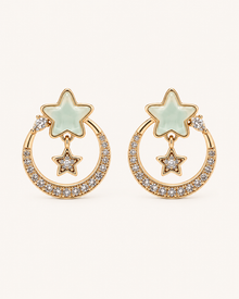 ANOVRA gold-tone celestial star earrings with mint-green stars and sparkling crystal hoops.
