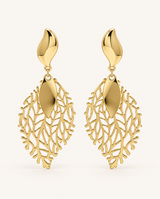 ANOVRA gold leaf drop earrings featuring intricate botanical openwork and polished golden detailing.