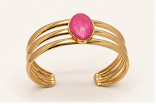 Anovra pink teardrop triple-band gold-tone cuff bracelet on #F9F5F0 cream background