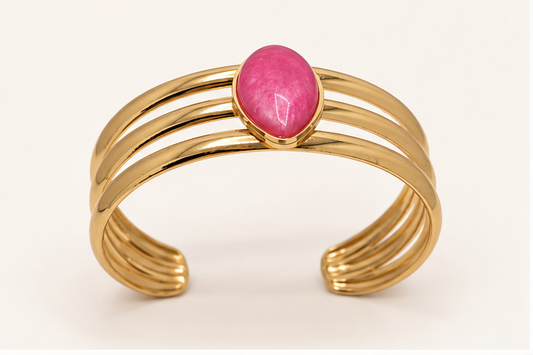 Anovra pink teardrop triple-band gold-tone cuff bracelet on #F9F5F0 cream background