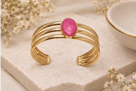 Anovra pink teardrop triple-band gold-tone cuff bracelet styled with minimal neutral props