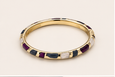 Anovra multicolor enamel gold-tone bangle bracelet on #F9F5F0 background