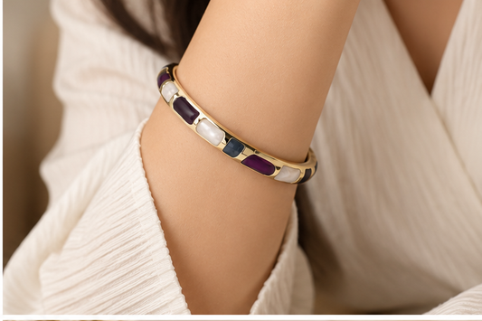 Anovra multicolor enamel gold-tone bangle bracelet worn on model wrist, face not visible