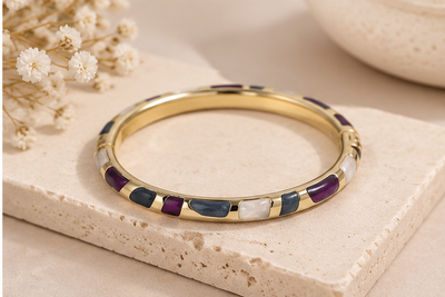 Anovra multicolor enamel gold-tone bangle bracelet styled with minimal neutral props