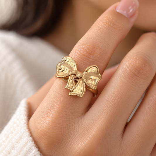Close-up of Anovra Golden Bow Statement Ring worn on model